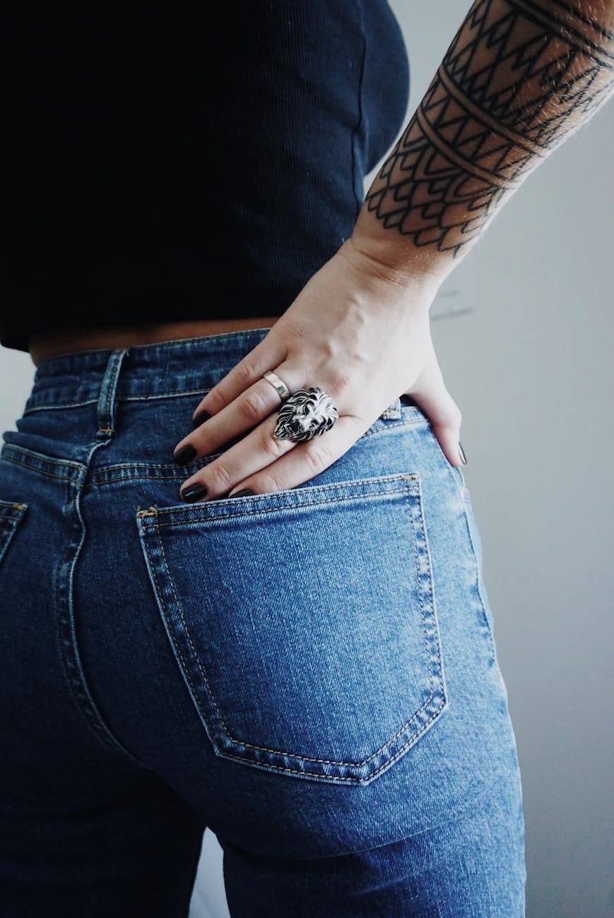 woman in blue jeans with hand on waist