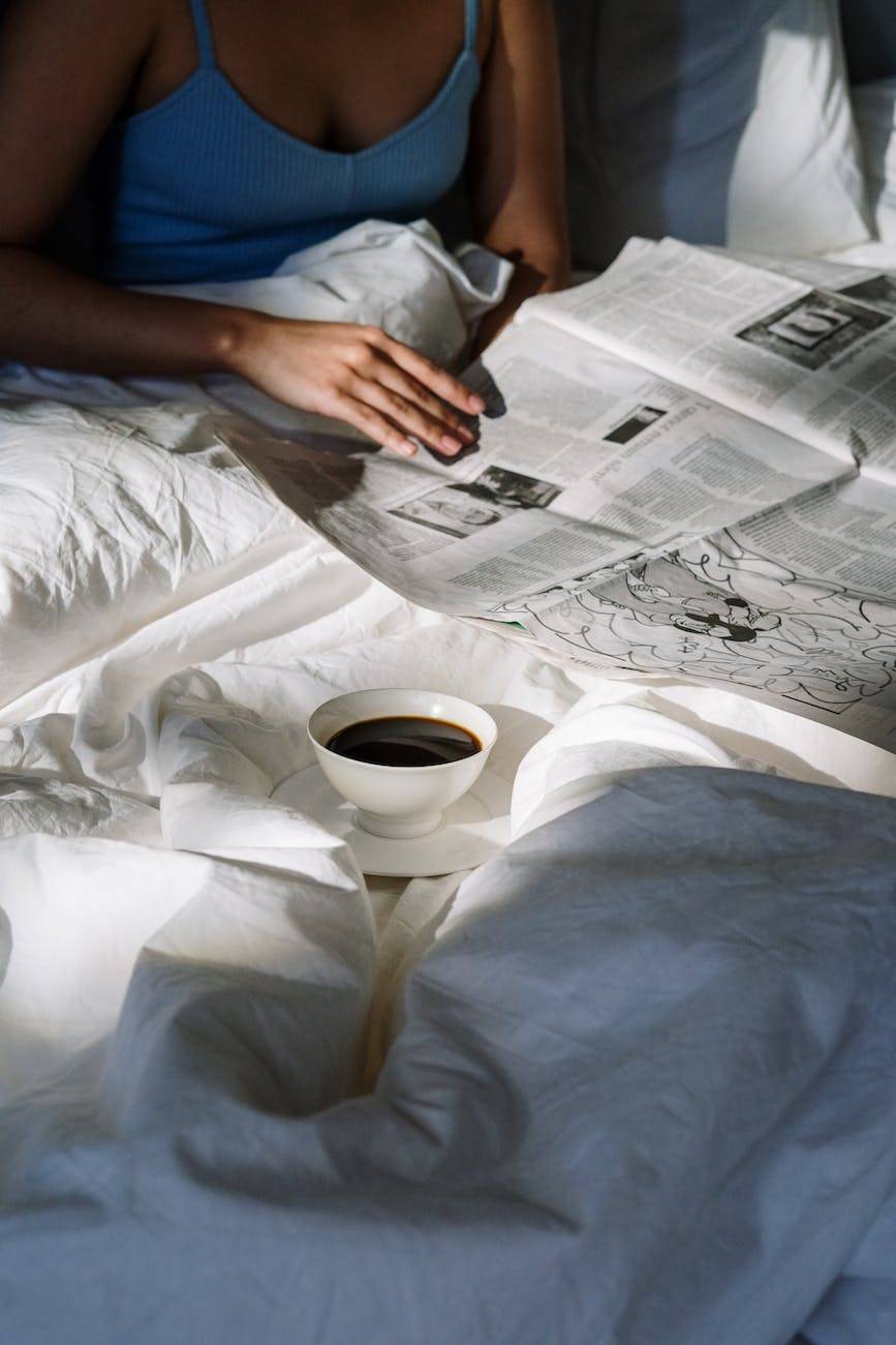 woman coffee hand bed